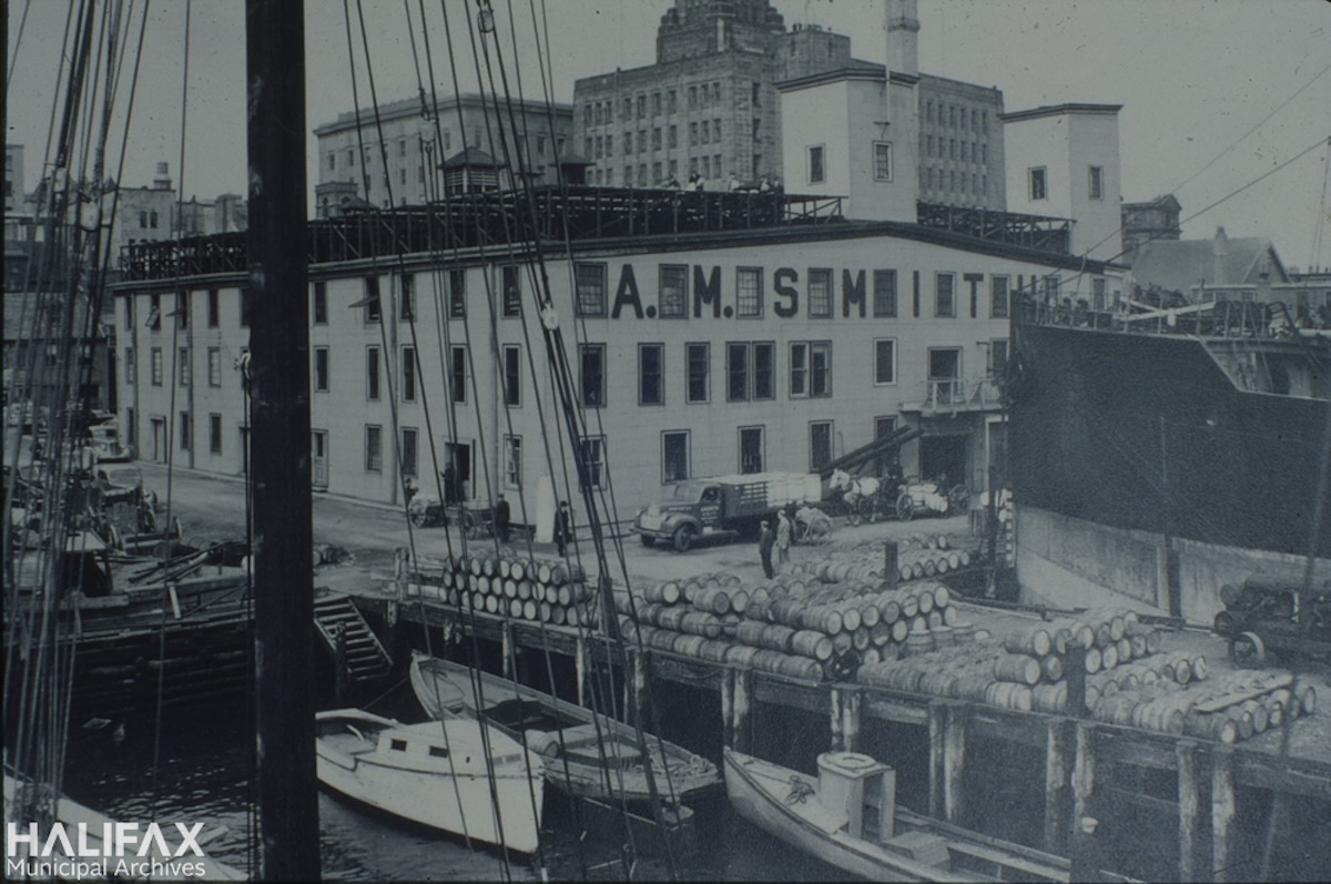 1930ca - A.M. Smith building and wharf, located on Lower Water St between Sackville and Prince streets-Halifax Municipal Archives, Halifax Tourism-102-104-E-7-5-77