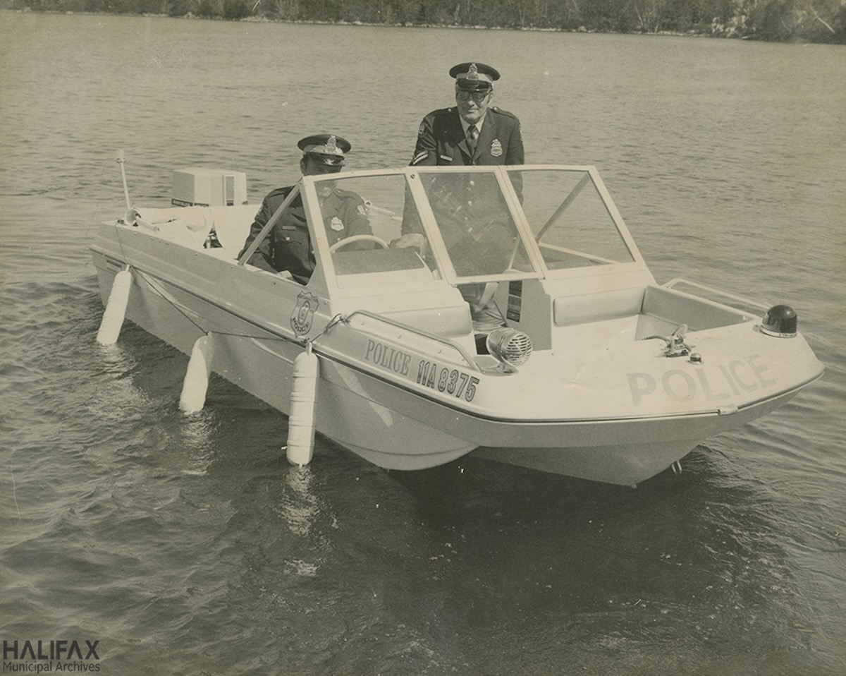 1960ca - Corporal Jack Friis and Constable Chris Hook at the front of a speedboat- HRM Archives, Halifax Police Department -102-16N-0045